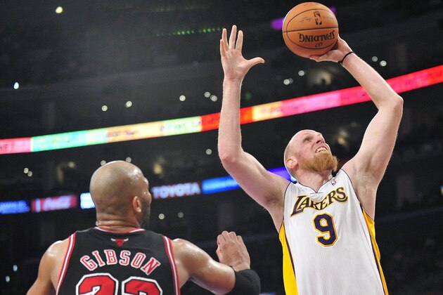 February 9, 2014; Los Angeles, CA, USA; Los Angeles Lakers center Chris Kaman (9) moves to the basket  against the defense of Chicago Bulls power forward Taj Gibson (22) during the second half at Staples Center. Mandatory Credit: Gary A. Vasquez-USA TODAY Sports