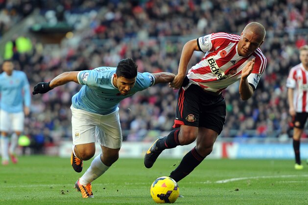 SUNDERLAND, ENGLAND - NOVEMBER 10: Wes Brown of Sunderland in action with Sergio Aguero of Manchester City during the Barclays Premier League match between Sunderland and Manchester City at Stadium of Light on November 10, 2013 in Sunderland, England. (Photo by Chris Brunskill/Getty Images)