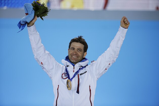 Men’s biathlon 10k sprint gold medalist Norway's Ole Einar Bjoerndalen celebrates on the podium during the medals ceremony at the 2014 Winter Olympics, Sunday, Feb. 9, 2014, in Sochi, Russia. (AP Photo/David Goldman)