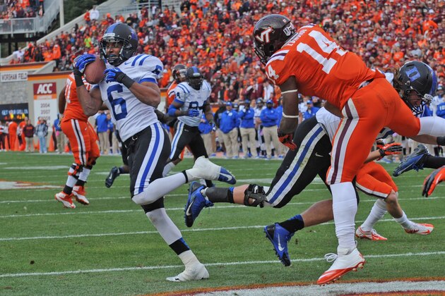 Duke defender Ross Cockrell (6) intercepts the ball in the end zone against Virginia Tech's Trey Edmonds (14) during the first half of an NCAA college football game in Blacksburg, Va., Saturday Oct. 26, 2013. (AP Photo/Don Petersen)