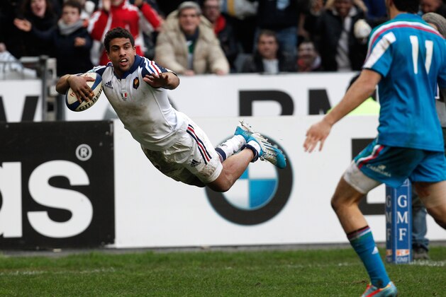 France's Wesley Fofana jumps to score a try during his Six Nations rugby union international match against Italy, at the Stade de France, in Saint Denis, outside Paris, Sunday, Feb 9, 2014. (AP Photo/Thibault Camus)
