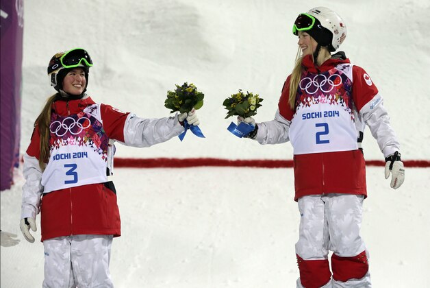 Canada's Justine Dufour-Lapointe, right, celebrates her gold medal in the women's moguls final, with her sister and silver medalist Chloe Dufour-Lapointe, left, at the Rosa Khutor Extreme Park, at the 2014 Winter Olympics, Saturday, Feb. 8, 2014, in Krasnaya Polyana, Russia.  (AP Photo/Andy Wong)