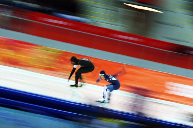 SOCHI, RUSSIA - FEBRUARY 10:  Shani Davis (L) of the United States and Junho Kim of South Korea compete during the Men's 500 m Race 1 of 2 Speed Skating event during day 3 of the Sochi 2014 Winter Olympics at Adler Arena Skating Center on February 10, 2014 in Sochi, Russia.  (Photo by Paul Gilham/Getty Images)