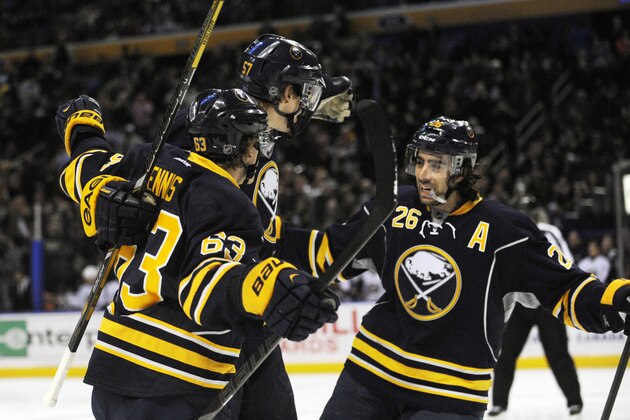 Buffalo Sabres' Tyler Ennis (63) and Matt Moulson (26) celebrate with Tyler Myers, center, after Myers scored a goal against the Columbus Blue Jackets during the first period of an NHL hockey game in Buffalo, N.Y., Saturday, Jan. 18, 2014. (AP Photo/Gary Wiepert)