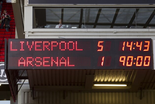 The scoreboard shows the final result as Liverpool beat Arsenal in their English Premier League soccer match at Anfield Stadium, Liverpool, England, Saturday Feb. 8, 2014. (AP Photo/Jon Super)