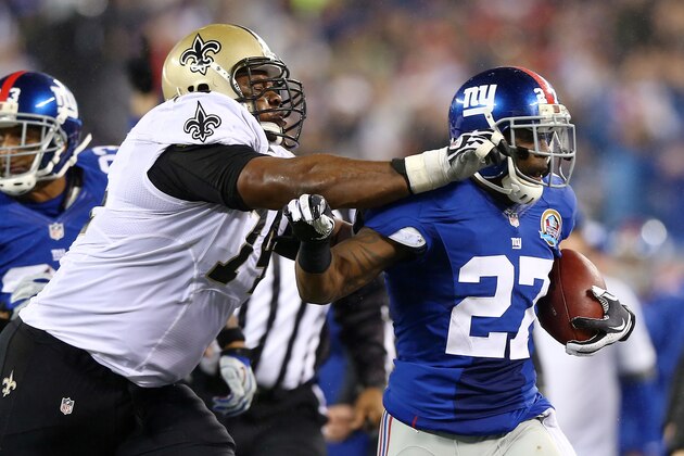 EAST RUTHERFORD, NJ - DECEMBER 09:  Stevie Brown #27 of the New York Giants is shoved out of bounds by Jermon Bushrod #74 of the New Orleans Saints on December 9, 2012 at MetLife Stadium in East Rutherford, New Jersey.  (Photo by Elsa/Getty Images)
