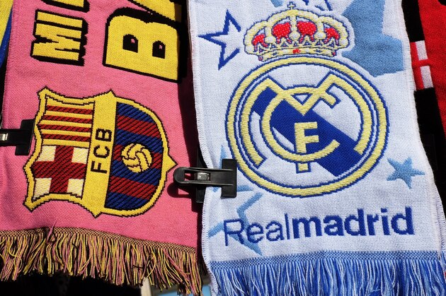 MADRID, SPAIN - DECEMBER 21:  Football scarves displaying the emblems of FC Barcelona and Real Madrid are sold on a stall on December 22, 2013 in Madrid, Spain. The European Union has opened a probe into whether Real Madrid, FC Barcelona and 5 other Spanish clubs have recieved unfair preferential treatment in the past from the government and public administrations.  (Photo by Denis Doyle/Getty Images)