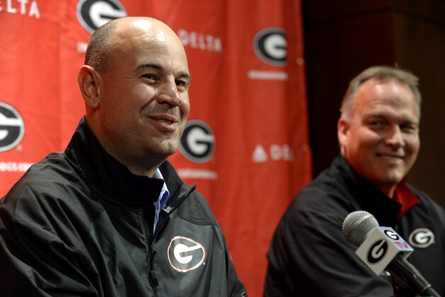 Jeremy Pruitt, left, is introduced as Georgia's new defensive coordinator by head football coach Mark Richt, right, during an NCAA college football news conference on Wednesday, Jan. 15, 2014, in Athens, Ga. The former Florida State defensive coordinator, who helped lead the Seminoles to the 2013 BCS championship, said he would build relationships with Bulldog players to build their trust. (AP Photo/David Tulis)