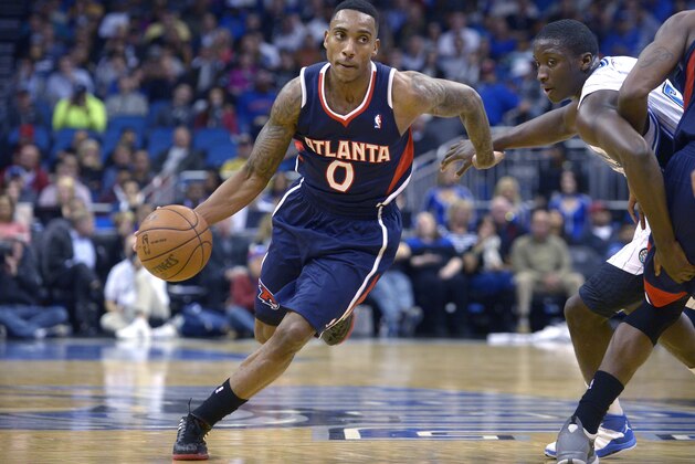 Atlanta Hawks point guard Jeff Teague (0) drives past Orlando Magic shooting guard Victor Oladipo, right, during the second half of an NBA basketball game in Orlando, Fla., Wednesday, Jan. 22, 2014. The Hawks won 112-109.(AP Photo/Phelan M. Ebenhack)