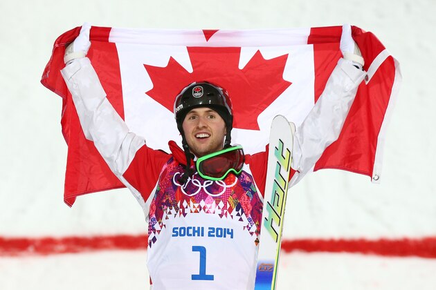 SOCHI, RUSSIA - FEBRUARY 10:  Gold medalist Alex Bilodeau of Canada celebrates during the flower ceremony for the Men's Moguls Finals on day three of the Sochi 2014 Winter Olympics at Rosa Khutor Extreme Park on February 10, 2014 in Sochi, Russia.  (Photo by Cameron Spencer/Getty Images)