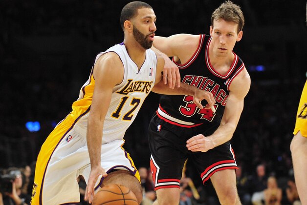 February 9, 2014; Los Angeles, CA, USA; Los Angeles Lakers point guard Kendall Marshall (12) controls the ball against Chicago Bulls small forward Mike Dunleavy (34) during the second half at Staples Center. Mandatory Credit: Gary A. Vasquez-USA TODAY Sports