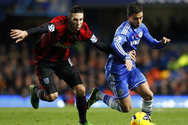 LONDON, ENGLAND - NOVEMBER 09: Chelsea's Eden Hazard looks to round Morgan Amalfitano of West Brom during the Barclays Premier League match between Chelsea and West Bromwich Albion at Stamford Bridge on November 09, 2013 in London, England. (Photo by Charlie Crowhurst/Getty Images)