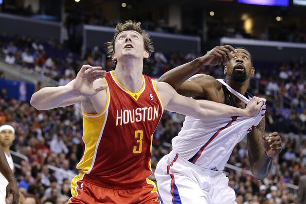 Houston Rockets' Omer Asik, left, of Turkey, and Los Angeles Clippers' DeAndre Jordan fight to get a rebound during the first half of an NBA basketball game on Monday, Nov. 4, 2013, in Los Angeles. (AP Photo/Jae C. Hong)