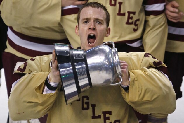 Boston College goalie Parker Milner raises the Beanpot trophy after defeating Northeastern 6-3 to win the championship game at the Beanpot college hockey tournament in Boston, Monday, Feb. 11, 2013. (AP Photo/Charles Krupa)