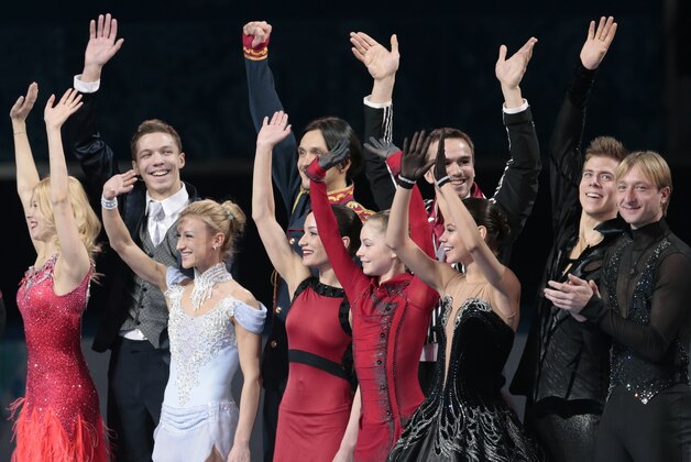 The Russian team wave to spectators as they stand on the podium during the flower ceremony after placing first in the team figure skating competition at the Iceberg Skating Palace during the 2014 Winter Olympics, Sunday, Feb. 9, 2014, in Sochi, Russia. (AP Photo/Ivan Sekretarev)