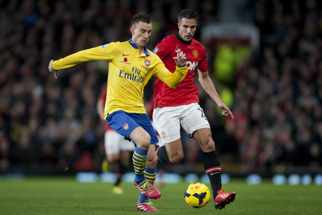Manchester United's Robin van Persie, right, fights for the ball against Arsenal's Laurent Koscielny during their English Premier League soccer match at Old Trafford Stadium, Manchester, England, Saturday Nov. 10, 2013. (AP Photo/Jon Super)