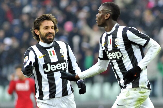 Juventus' Paul Pogba, of France, left, celebrates with his teammate Andrea Pirlo after scoring during a Serie A soccer match between Juventus and Siena at the Juventus Stadium in Turin, Italy, Sunday, Feb 24, 2013. (AP Photo/Massimo Pinca)