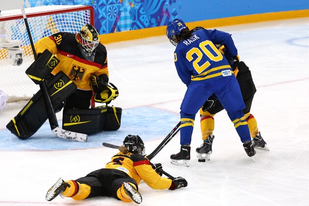 SOCHI, RUSSIA - FEBRUARY 11: Fanny Rask #20 of Sweden fights for the puck against Jessica Hammerl #4 and Jennifer Harss #30 of Germany during the Women's Ice Hockey Preliminary Round Group B game on day four of the Sochi 2014 Winter Olympics at Shayba Arena on February 11, 2014 in Sochi, Russia.  (Photo by Martin Rose/Getty Images)