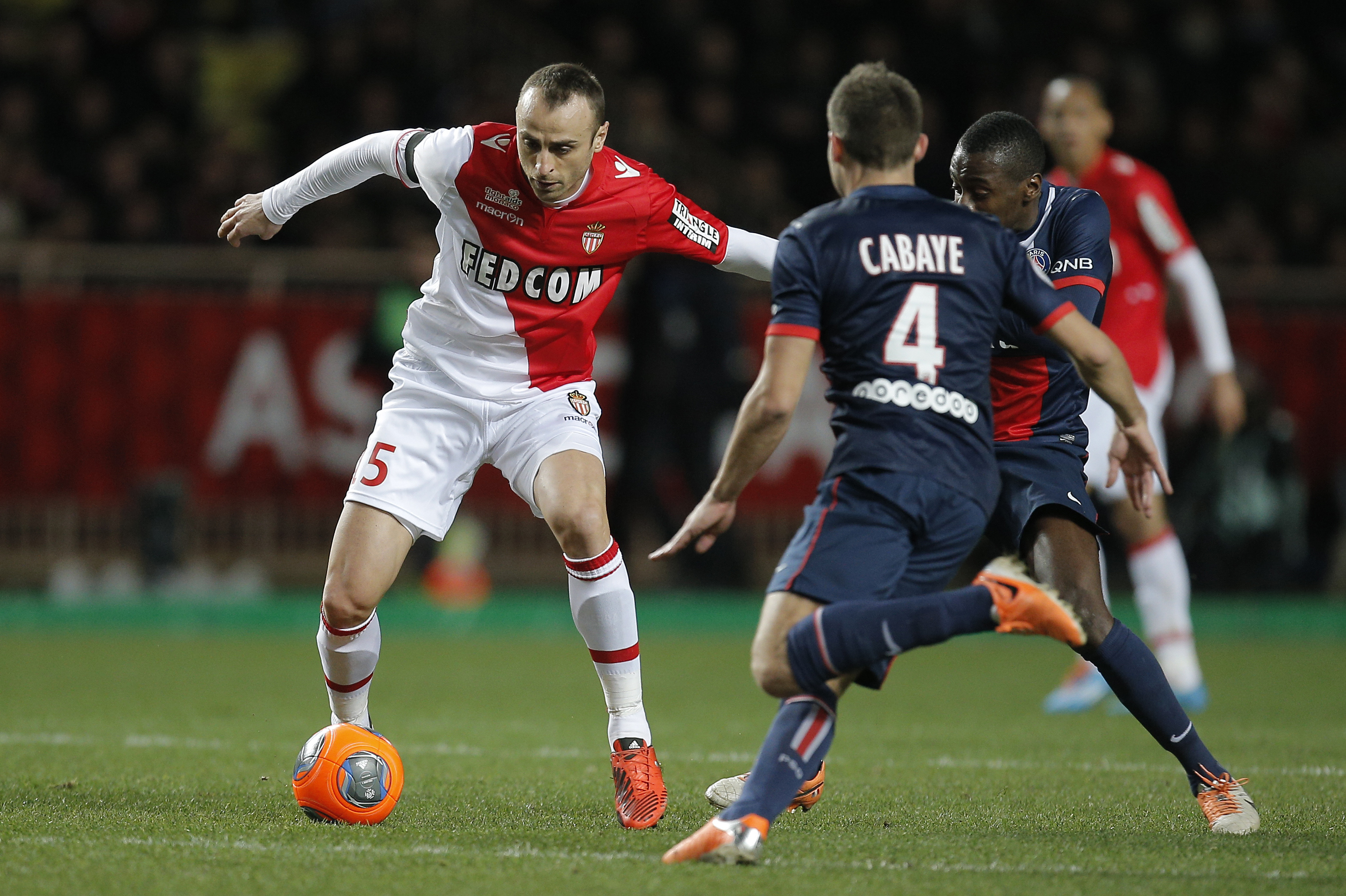 Monaco's Dimitar Berbatov of Bulgaria challenges for the ball with Paris Saint Germain's Yohan cabaye of France during their French League One soccer match, in Monaco stadium, Sunday, Feb. 9 , 2014. (AP Photo/Lionel Cironneau)