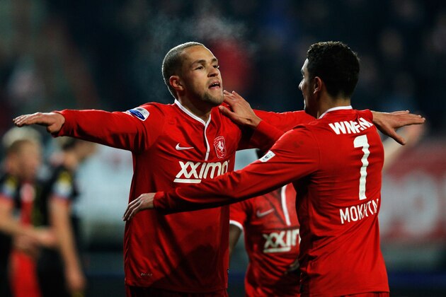 ENSCHEDE, NETHERLANDS - DECEMBER 14:  Luc Castaignos of Twente celebrates scoring the second goal of the game with team mate Youness Mokhtar (#7) during the Eredivisie match between FC Twente and Go Ahead Eagles at De Grolsch Veste Stadium on December 14, 2013 in Enschede, Netherlands.  (Photo by Dean Mouhtaropoulos/Getty Images)