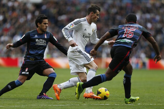 Real Madrid's Gareth Bale from Great Britain, centre, in action with Granada's Brayan Angulo, right, and Granada's Jose Luis Garcia