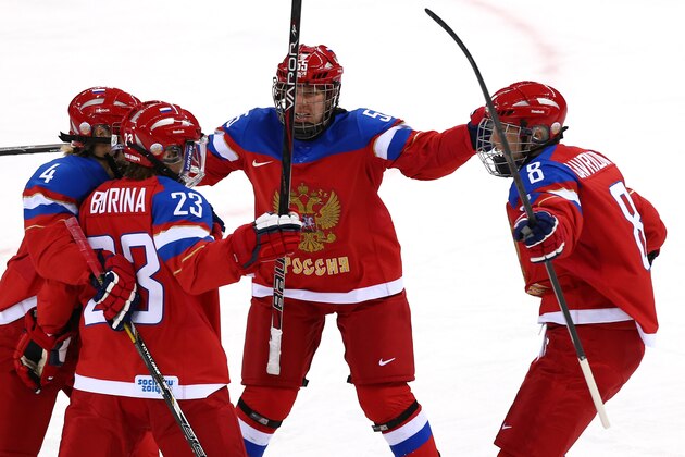 SOCHI, RUSSIA - FEBRUARY 11:  Tatyana Burina #23 of Russia celebrates with her teammates after scoring a goal in the first period against Nana Fujimoto #30 of Japan during the Women's Ice Hockey Preliminary Round Group B game on day four of the Sochi 2014 Winter Olympics at Shayba Arena on February 11, 2014 in Sochi, Russia.  (Photo by Martin Rose/Getty Images)