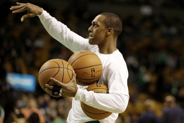 Boston Celtics point guard Rajon Rondo (9) holds three balls aqs he takes practice shots before the first half of their NBA basketball game against the Dallas Mavericks in Boston, Sunday, Feb. 9, 2014. The Mavericks defeated the Celtics 102-91. (AP Photo/Stephan Savoia)