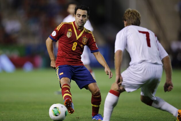 Spain's midfielder Xavier Hernandez, left, vies for the ball with Georgia's Shota Grigalashvili, right, during a 2014 World Cup Group I qualifying soccer match between Spain and Georgia at the Carlos Belmonte stadium in Albacete, Spain, Tuesday Oct. 15, 2013. (AP Photo/Fernando Bustamante)