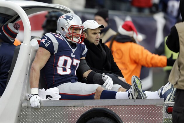 FILE - In this Sunday, Dec. 8, 2013, file photo, New England Patriots tight end Rob Gronkowski is carted off the field after getting injured in the third quarter of an NFL football game against the Cleveland Browns in Foxborough, Mass. Gronkowski's season ended abruptly Sunday with a knee injury when he took a low hit from Cleveland Browns safety T.J. Ward. No penalty was called.  (AP Photo/Steven Senne, File)