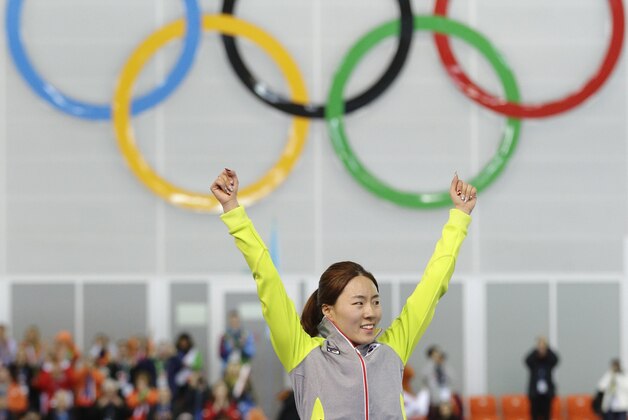Gold medallist South Korea's Lee Sang-hwa during the flower ceremony for the women's 500-meter speedskating race at the Adler Arena Skating Center during the 2014 Winter Olympics, Tuesday, Feb. 11, 2014, in Sochi, Russia. (AP Photo/Patrick Semansky)