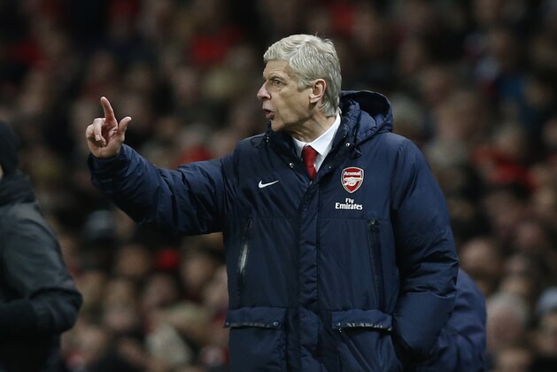 Arsenal's manager Arsene Wenger gestures as he watches his team play against Crystal Palace during their English Premier League soccer match at Emirates Stadium in London, Sunday, Feb. 2, 2014. (AP Photo/Sang Tan)