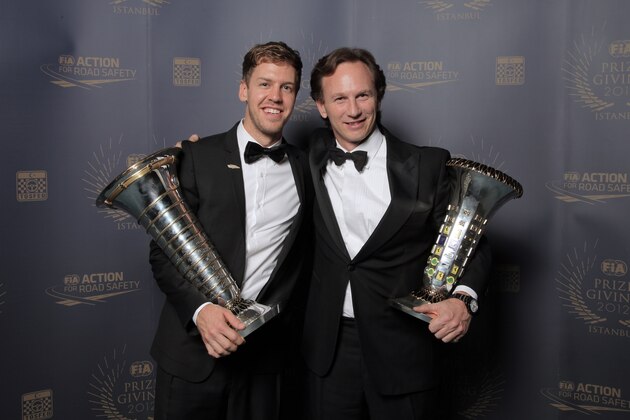 ISTANBUL, TURKEY - DECEMBER 7:  In this handout provided by Federation Internationale de l'Automobile (FIA), FIA Formula One World Championship award winners Sebastian Vettel of Germany and Red Bull Racing team principal Christian Horner hold their awards, presented at the FIA Prize Giving Gala 2012 on December 7, 2012 in Istanbul, Turkey. (Photo by FIA via Getty Images)