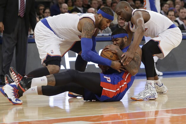 New York Knicks' Carmelo Anthony (7) and teammate Raymond Felton (2) fight for control of the ball with Detroit Pistons' Josh Smith (6) during the first half of an NBA Basketball game Tuesday, Jan. 7, 2014, in New York.  (AP Photo/Frank Franklin II)