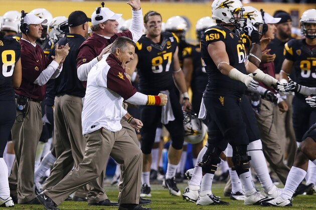 Arizona State coach Todd Graham, left,  pumps his fist as he celebrates a defensive stop against Arizona during the second half of an NCAA college football game Saturday, Nov. 30, 2013, in Tempe, Ariz. Arizona State defeated Arizona 58-21. (AP Photo/Ross D. Franklin)