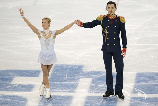 Tatiana Volosozhar and Maxim Trankov of Russia complete their routine in the pairs short program figure skating competition at the Iceberg Skating Palace during the 2014 Winter Olympics, Tuesday, Feb. 11, 2014, in Sochi, Russia. (AP Photo/Bernat Armangue)