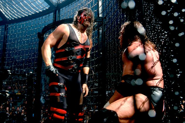 Kane and Triple H battle inside the Elimination Chamber.