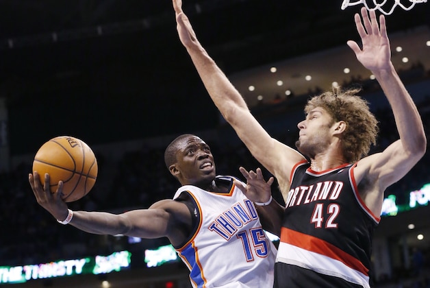 Oklahoma City Thunder guard Reggie Jackson (15) shoots as Portland Trail Blazers center Robin Lopez (42) defends in the third quarter of an NBA basketball game in Oklahoma City, Tuesday, Jan. 21, 2014. Oklahoma City won 105-97. (AP Photo/Sue Ogrocki)