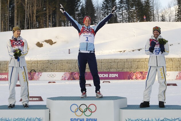 Norway's gold medal winner Ola Vigen Hattestad is flanked by Sweden's silver medal winner Teodor Peterson, left, and Sweden's  bronze medal winner Emil Joensson during the flower ceremony of the men's cross-country sprint final at the 2014 Winter Olympics, Tuesday, Feb. 11, 2014, in Krasnaya Polyana, Russia. (AP Photo/Gregorio Borgia)