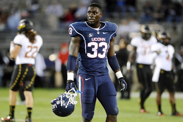 Connecticut linebacker Yawin Smallwood walks on the field before an NCAA college football game against Maryland at Rentschler Field in East Hartford, Conn., Saturday, Sept. 14, 2013. (AP Photo/Jessica Hill)