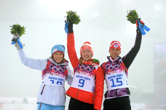 SOCHI, RUSSIA - FEBRUARY 11:  (L-R) Silver medalist Tora Berger of Norway, gold medalist Darya Domracheva of Belarus and bronze medalist Teja Gregorin of Slovenia stand on the podium during the flower ceremony for the the Women's 10 km Pursuit during day four of the Sochi 2014 Winter Olympics at Laura Cross-country Ski & Biathlon Center on February 11, 2014 in Sochi, Russia.  (Photo by Harry How/Getty Images)