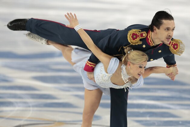 Tatiana Volosozhar and Maxim Trankov of Russia compete in the pairs short program figure skating competition at the Iceberg Skating Palace during the 2014 Winter Olympics, Tuesday, Feb. 11, 2014, in Sochi, Russia. (AP Photo/Ivan Sekretarev)