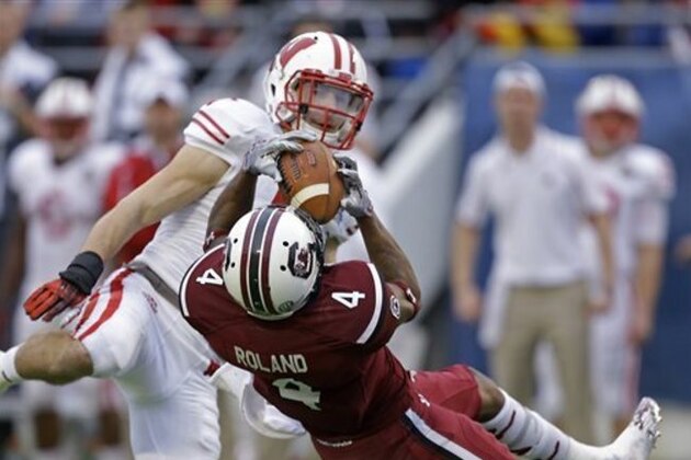 South Carolina wide receiver Shaq Roland (4) catches a long pass in front of Wisconsin safety Michael Caputo, back, during the second half of the Capital One Bowl NCAA college football game in Orlando, Fla., Wednesday, Jan. 1, 2014. South Carolina won 34-24. (AP Photo/John Raoux) South Carolina wide receiver Shaq Roland (4) catches a long pass in front of Wisconsin safety Michael Caputo, back, during the second half of the Capital One Bowl NCAA college football game in Orlando, Fla., Wednesday, Jan. 1, 2014. South Carolina won 34-24. (AP Photo/John Raoux)