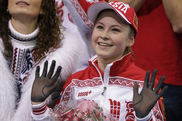 Julia Lipnitskaia of Russia waves to spectators in the results area after competing in the women's team free skate figure skating competition at the Iceberg Skating Palace during the 2014 Winter Olympics, Sunday, Feb. 9, 2014, in Sochi, Russia. (AP Photo/Darron Cummings, Pool)