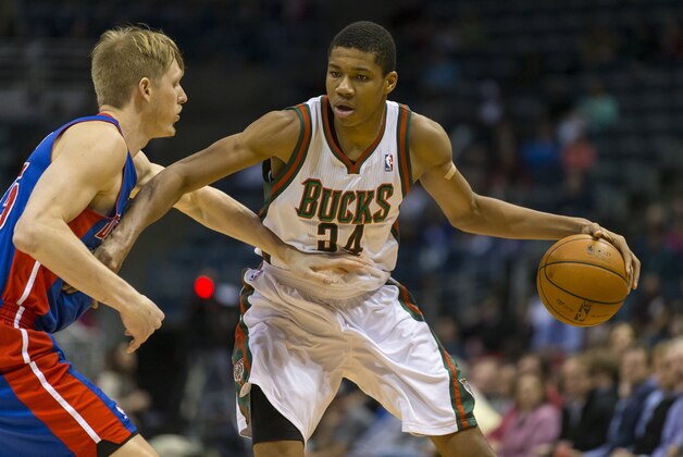 Dec 4, 2013; Milwaukee, WI, USA; Milwaukee Bucks guard Giannis Antetokounmpo (34) dribbles the ball as Detroit Pistons forward Kyle Singler (25) defends during the third quarter at BMO Harris Bradley Center. Detroit won 105-98.  Mandatory Credit: Jeff Hanisch-USA TODAY Sports