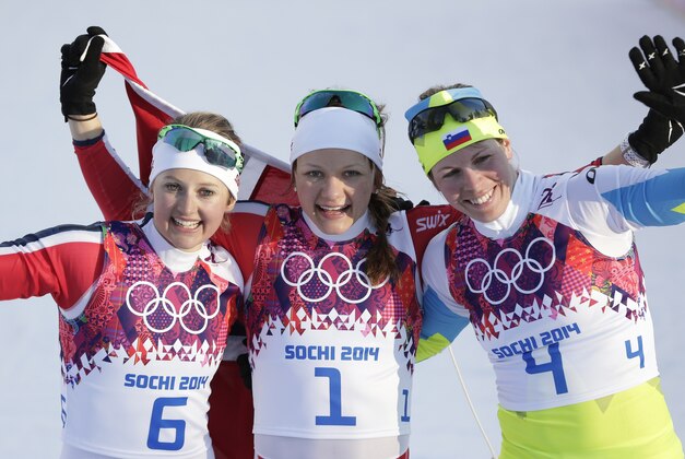 Norway's gold medal winner Maiken Caspersen Falla is flanked by silver medal winner Ingvild Flugstad Oestberg from Norway, left, and Slovenia's bronze medal winner Vesna Fabjan after the women's cross-country sprint the 2014 Winter Olympics, Tuesday, Feb. 11, 2014, in Krasnaya Polyana, Russia. (AP Photo/Matthias Schrader)