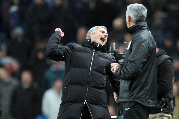 Chelsea's manager Jose Mourinho, left, celebrates victory at the end of the game during their English Premier League soccer match against Manchester City at the Etihad stadium in Manchester, England, Monday Feb. 3, 2014. (AP Photo/Clint Hughes)