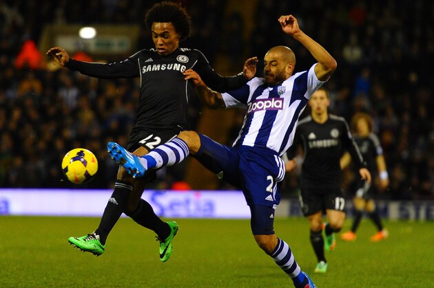 WEST BROMWICH, ENGLAND - FEBRUARY 11:  Willian of Chelsea is tackled Steven Reid of West Brom during the Barclays Premier League match between West Bromwich Albion and Chelsea at The Hawthorns on February 11, 2014 in West Bromwich, England.  (Photo by Laurence Griffiths/Getty Images)