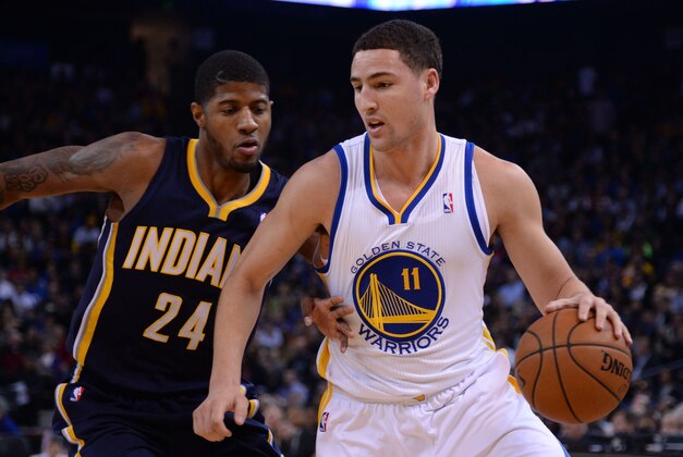 January 20, 2014; Oakland, CA, USA; Golden State Warriors shooting guard Klay Thompson (11) dribbles Indiana Pacers small forward Paul George (24) during the first quarter at Oracle Arena. Mandatory Credit: Kyle Terada-USA TODAY Sports