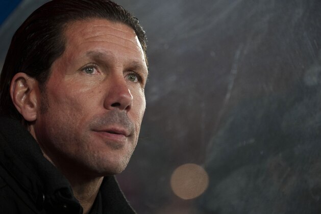 Atletico's coach Diego Pablo Simeone from Argentina waits for the start of a Spanish La Liga soccer match between Almeria and Atletico de Madrid at the Juegos Mediterraneos stadium in Almeria, Spain Saturday Feb. 8, 2014. (AP Photo/Daniel Tejedor)