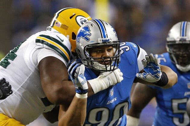 Detroit Lions defensive tackle Ndamukong Suh (90) rushes agains the Green Bay Packers during the second quarter of an NFL football game at Ford Field in Detroit, Thursday, Nov. 28, 2013. (AP Photo/Paul Sancya)
